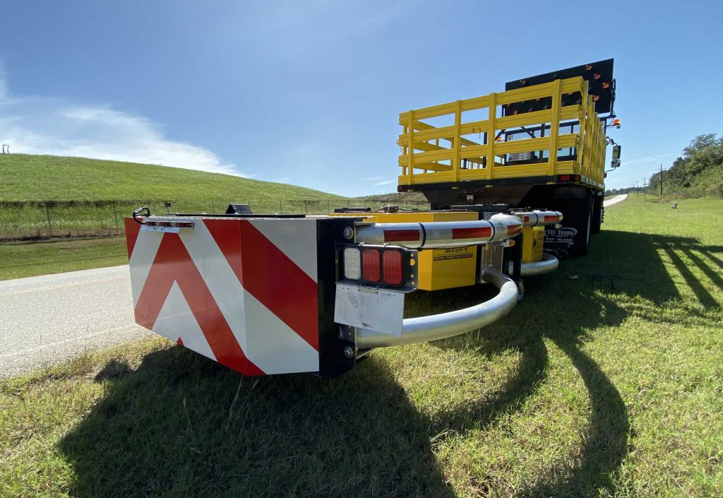 rear view of large work truck with custom flatbed trailer